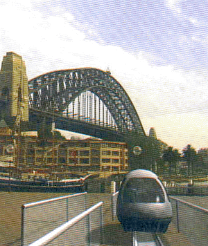 Concept rendering of a vehicle on a waterside guideway with the Sydney Harbour Bridge in the background